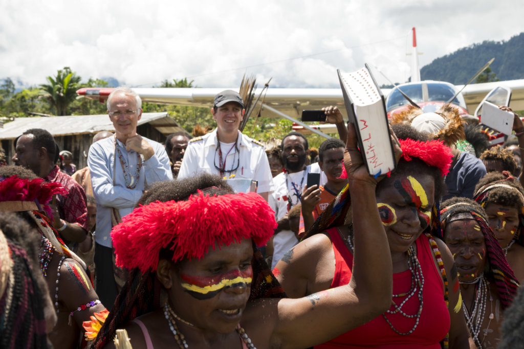 Yali people celebrate the entire Bible in their heart language airplane in background