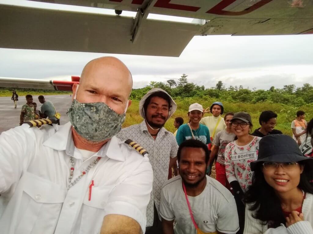 mission aviation fellowship charity pilot delivers supplies to teachers in a remote village 