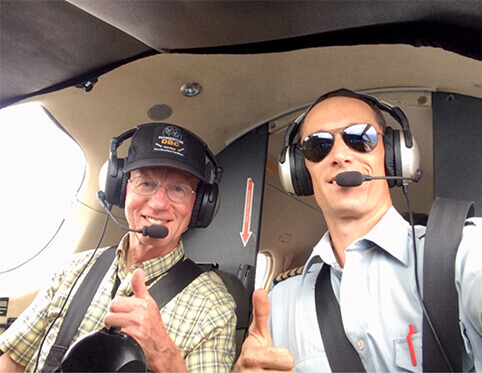 Mike Rowles, left, flies with Nick Frey in the DRC. Photo by Nick Frey.