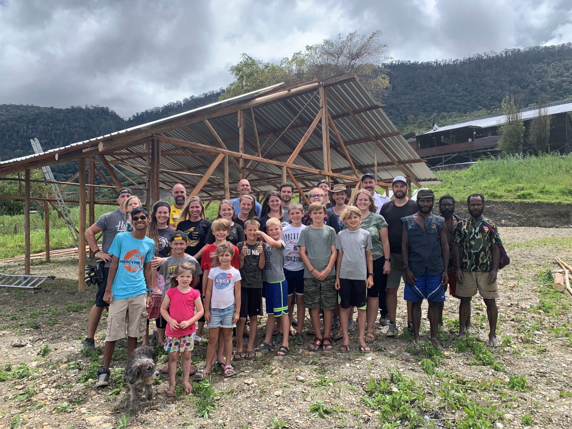 Mission Aviation Fellowship families help build a structure for gospel teaching in Papua, Indonesia.
